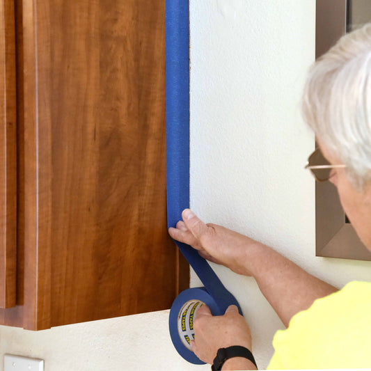 Painters tape being used to create straight painting lines