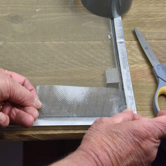 screen repair tape being used on damaged screen window